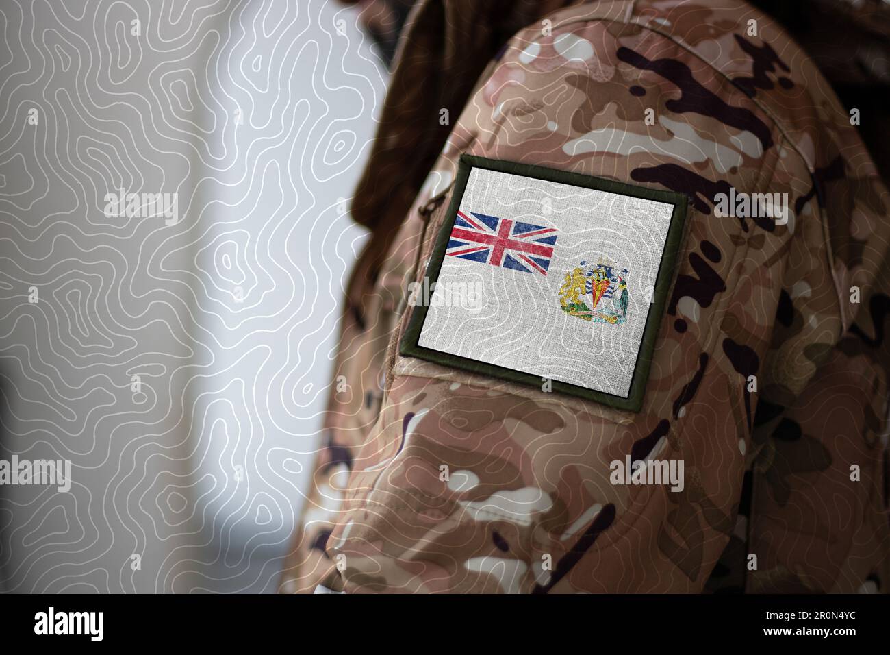 British Antarctic Territory Soldier. Soldier with flag British Antarctic Territory, British Antarctic Territory flag on a military uniform. Camouflage Stock Photo