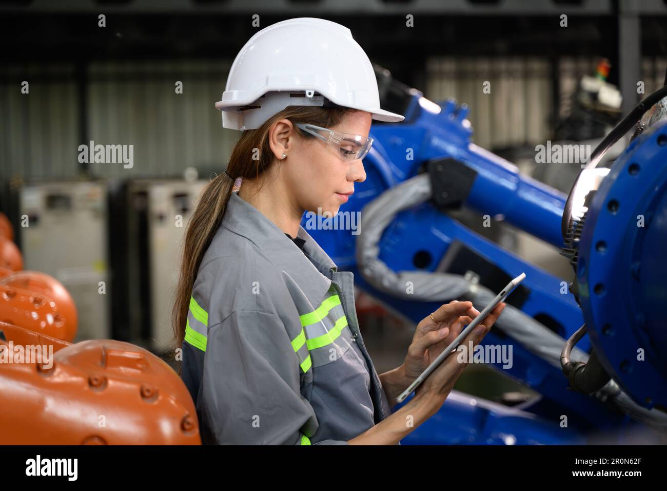 Maintenance engineer worker working with robotic machine automation ...
