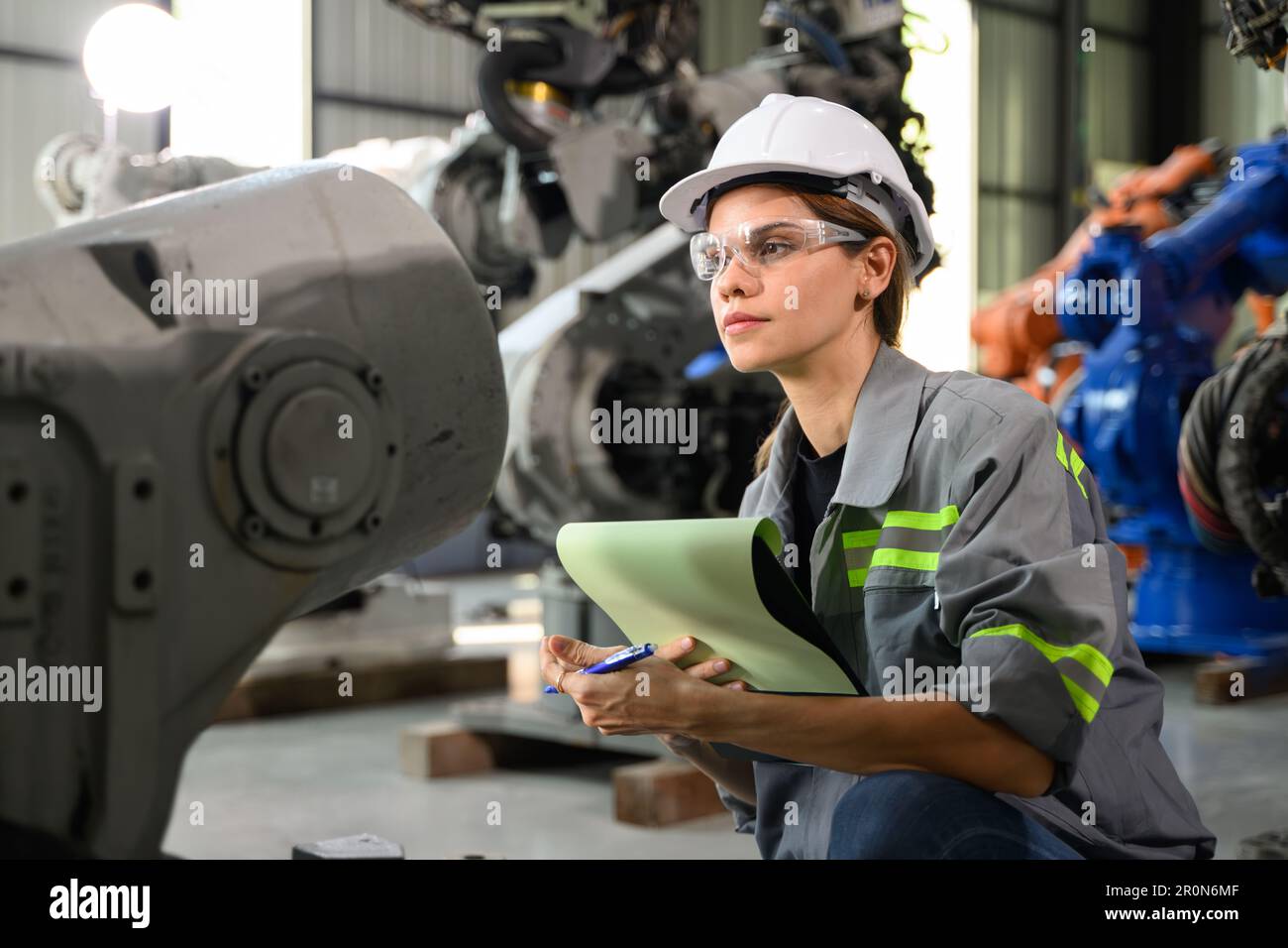 Maintenance engineer worker working with robotic machine automation ...
