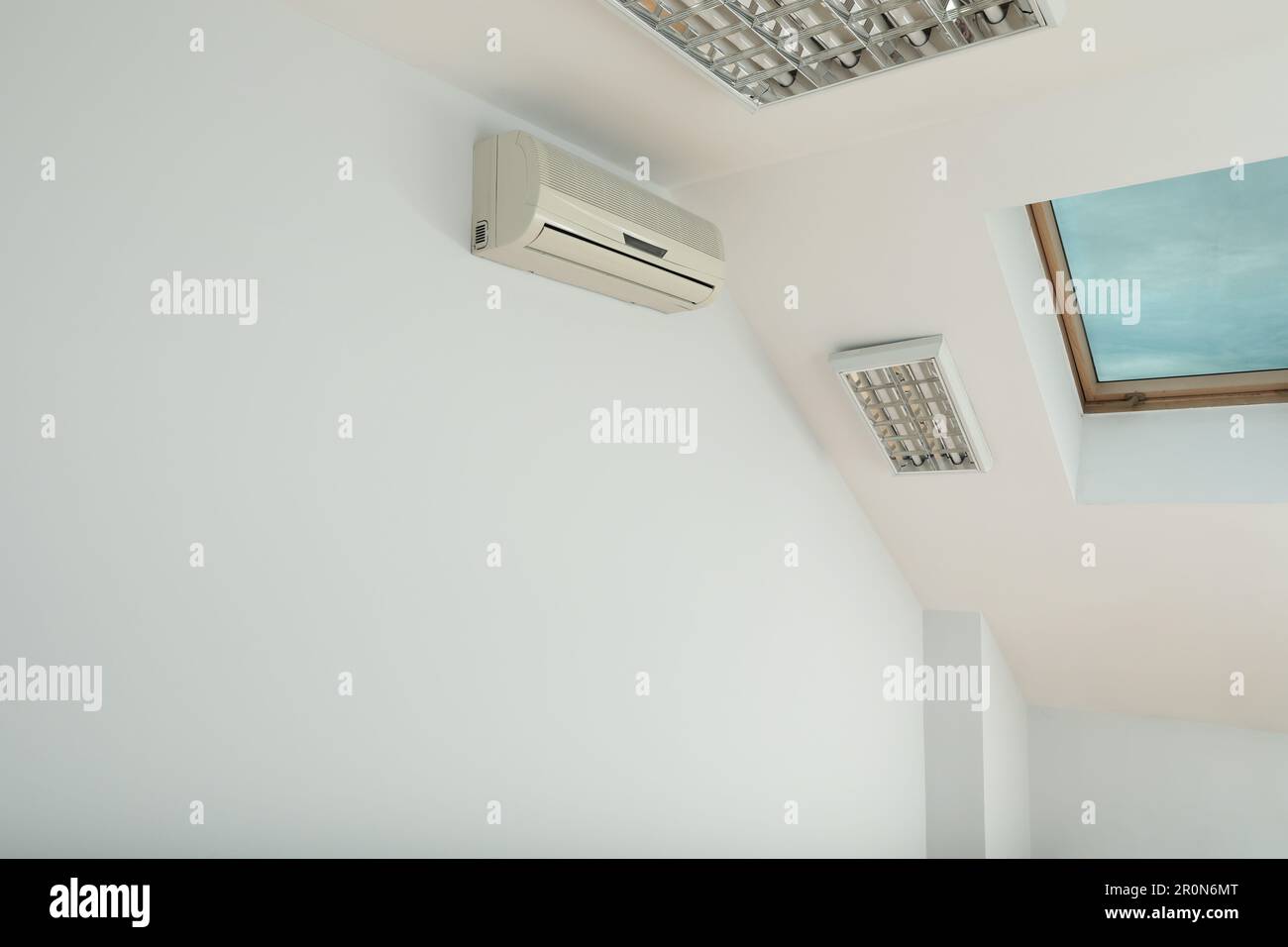 Modern air conditioner on white wall indoors Stock Photo - Alamy