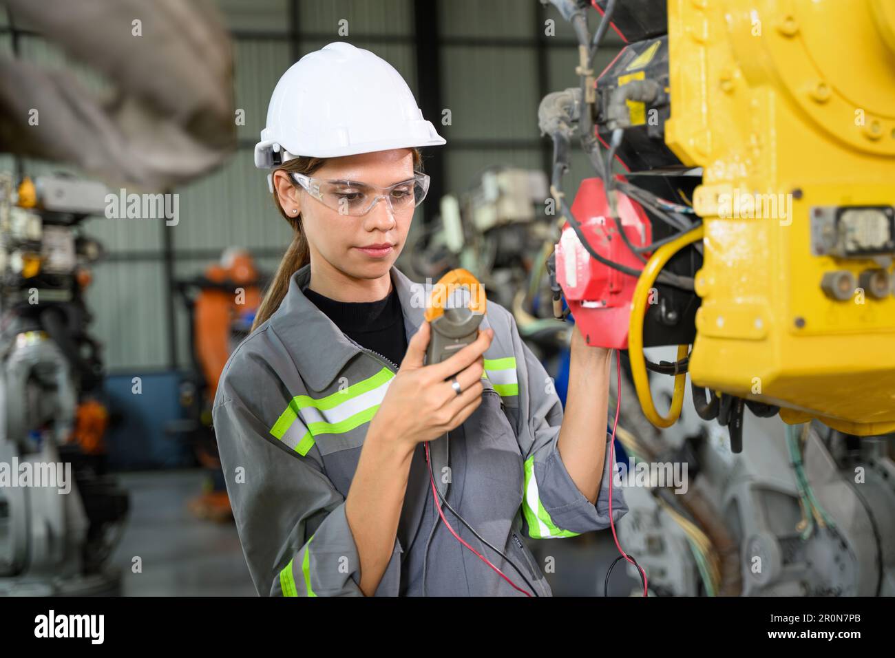 Maintenance engineer worker working with robotic machine automation ...