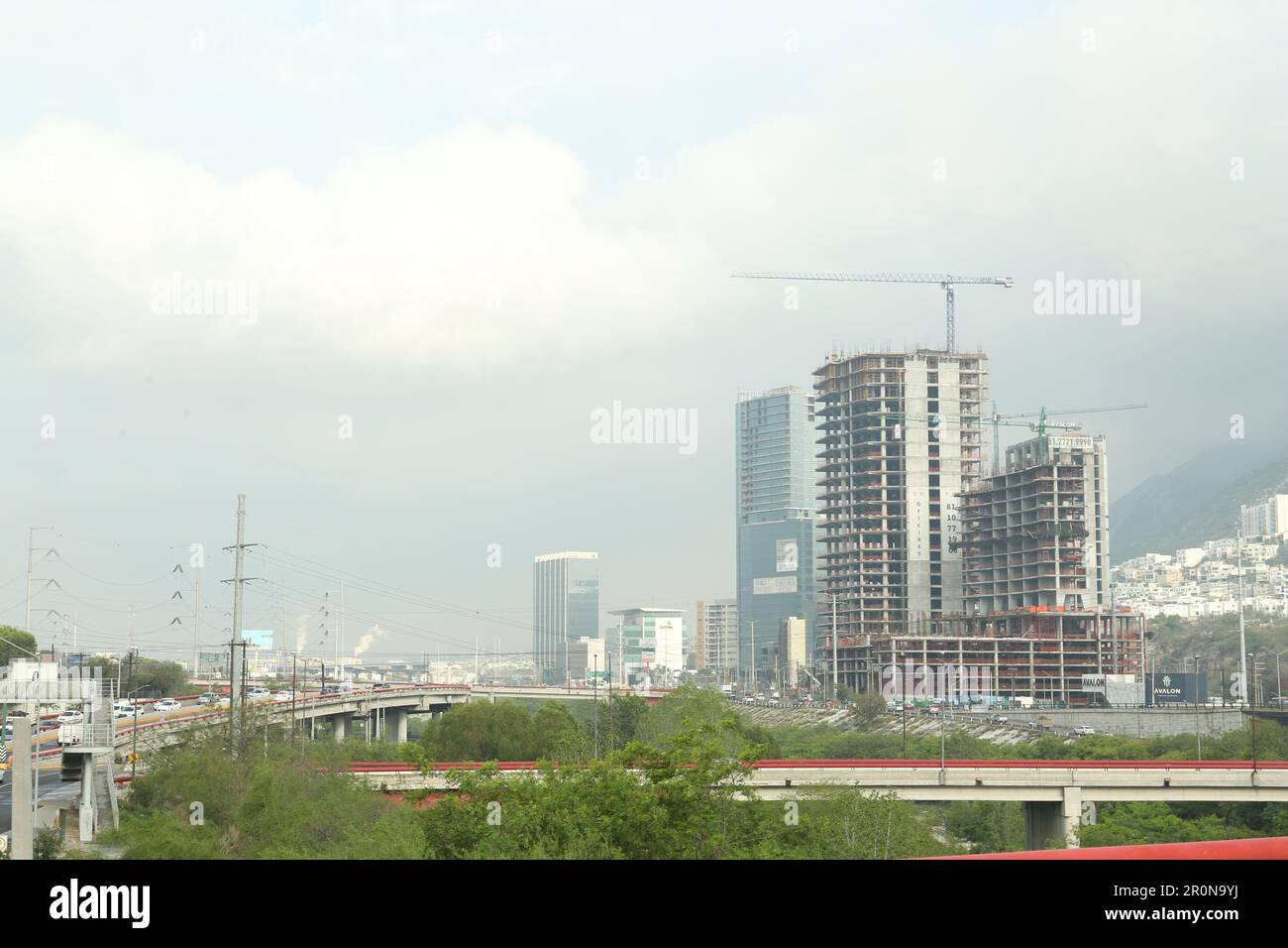 Beautiful view of unfinished buildings and road near mountains Stock Photo