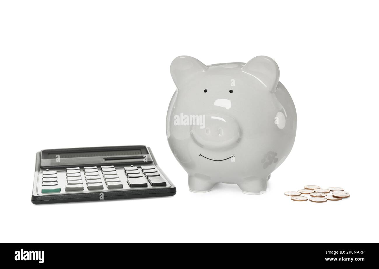Piggy bank, coins and calculator on white background Stock Photo - Alamy
