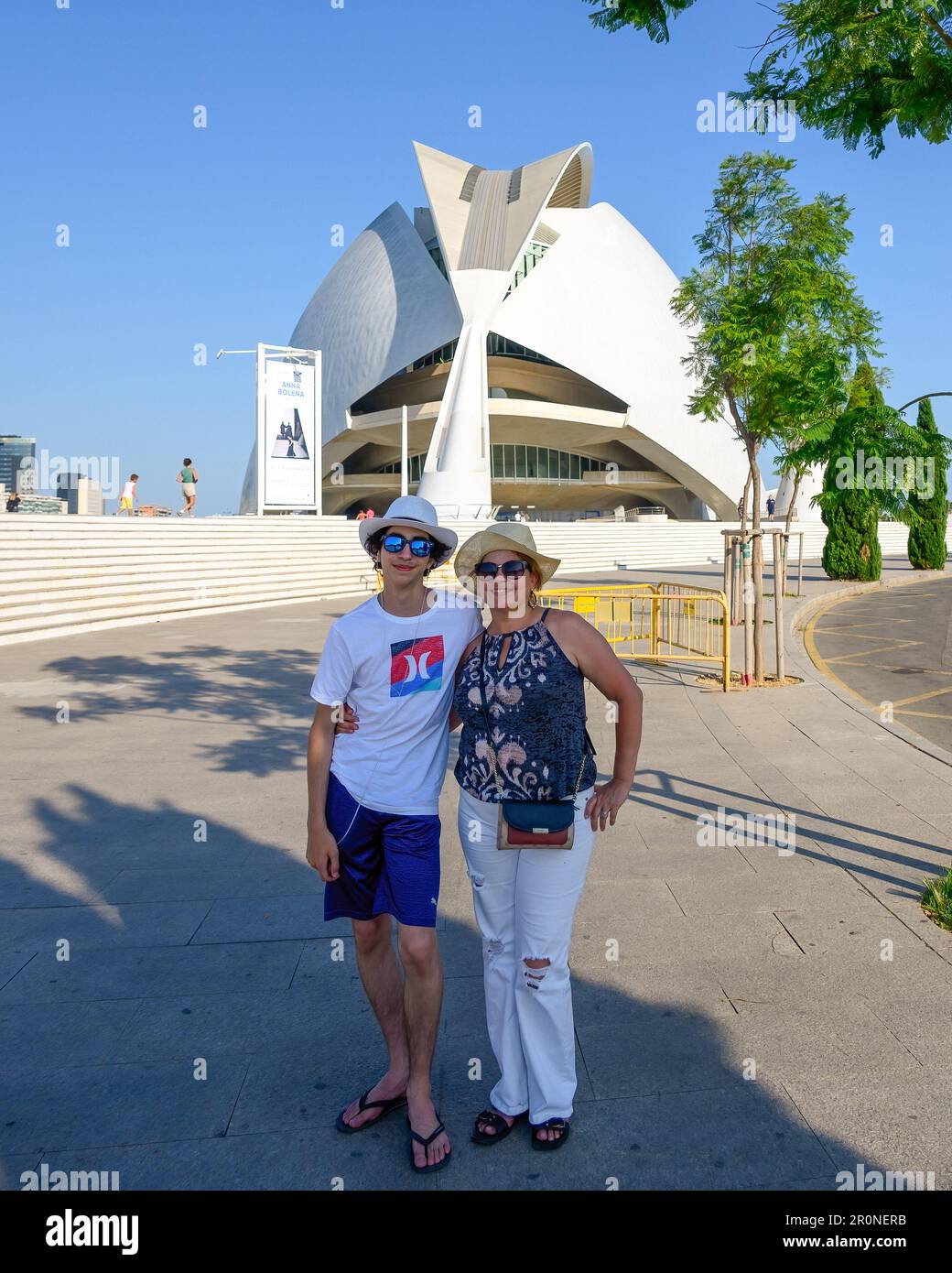Valencia, Spain - July 17, 2022: Portrait of a Latin American family doing tourism. The Palau de les Arts or Palace of Arts is the background. Candid Stock Photo