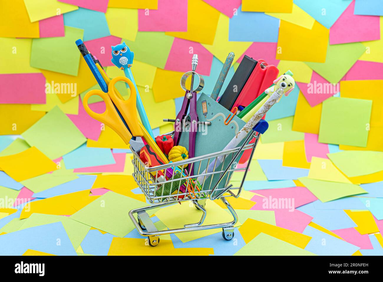 Bright stationery objects in mini supermarket cart on background of ...