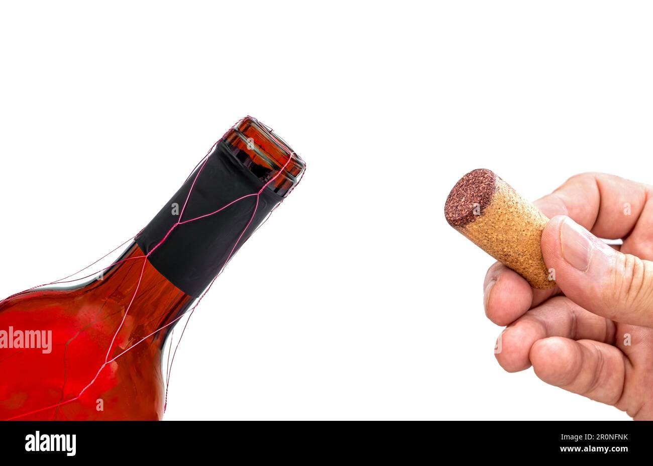 Red wine bottle isolated against white with hand holding the stopper by