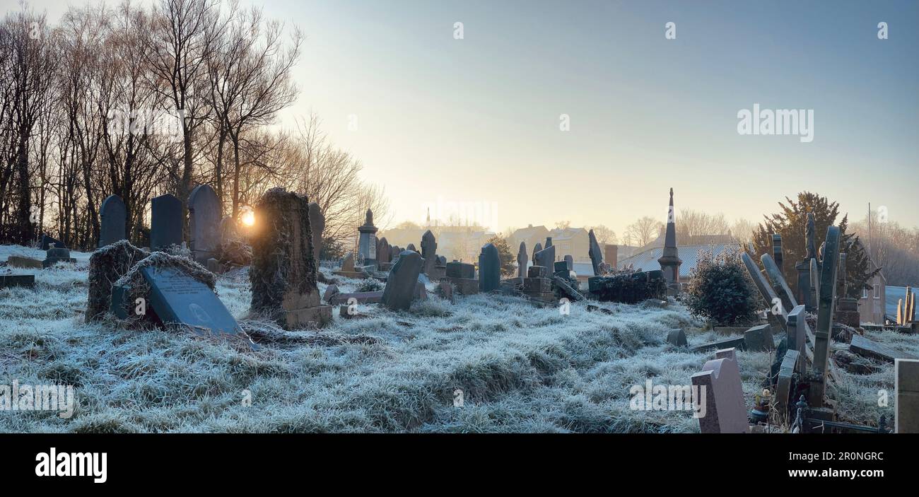 Frost covered graveyard on a winters morning in the churchyard of the old Methodist Church on St George's Road. Leaning gravestones at strange angles. Stock Photo