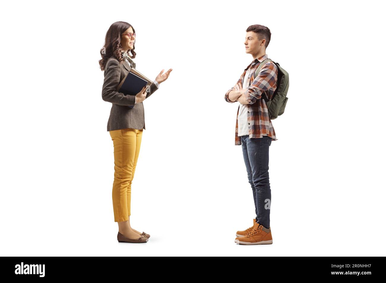 Female teacher talking to a male teenage student isolated on white ...