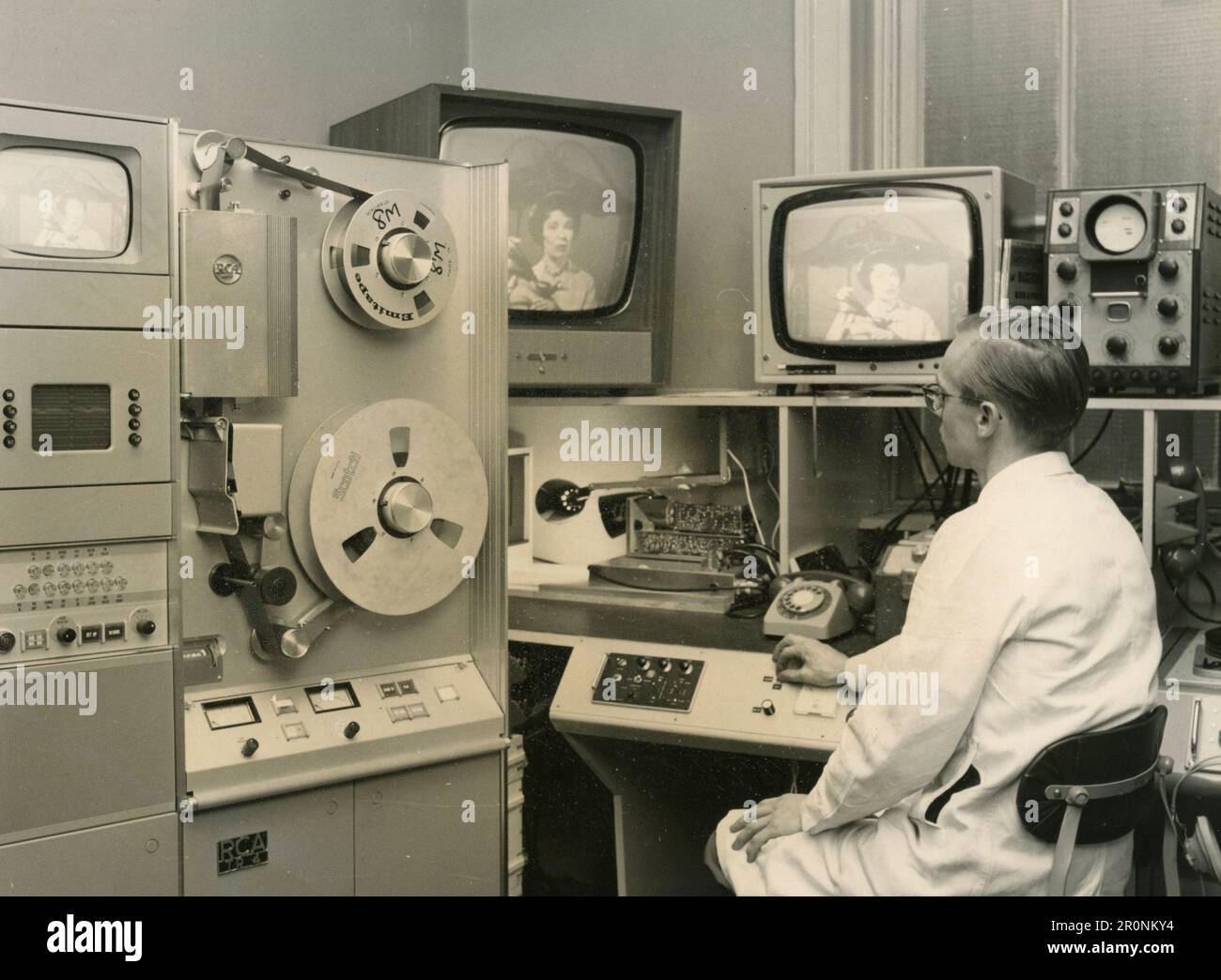 An operator supervises the transmission in the control room of the Educational TV Centre, Glasgow, Scotland 1965 Stock Photo