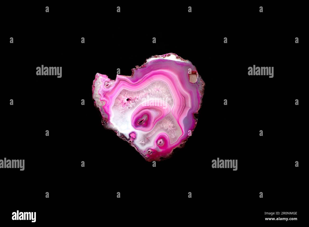 Pink agate macro detail black isolated background. close-up polished semi-precious gemstone copy space Stock Photo