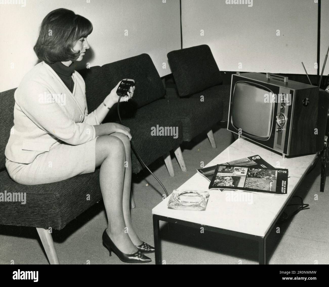 Model showing a new television set with remote control, UK 1966 Stock Photo Alamy