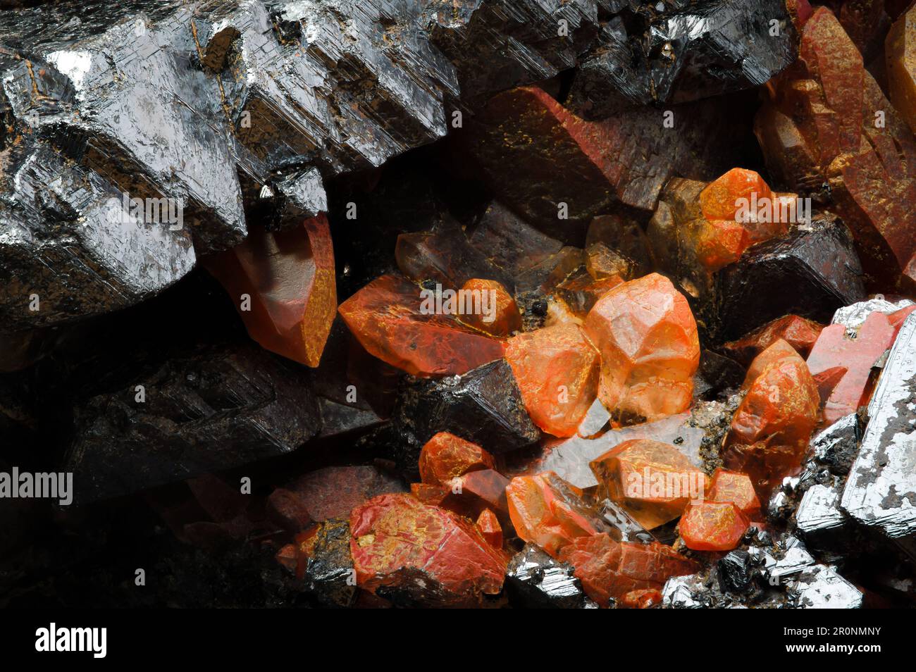 hematoid quartz on magnetite macro detail texture background. close-up raw rough unpolished semi-precious gemstone Stock Photo