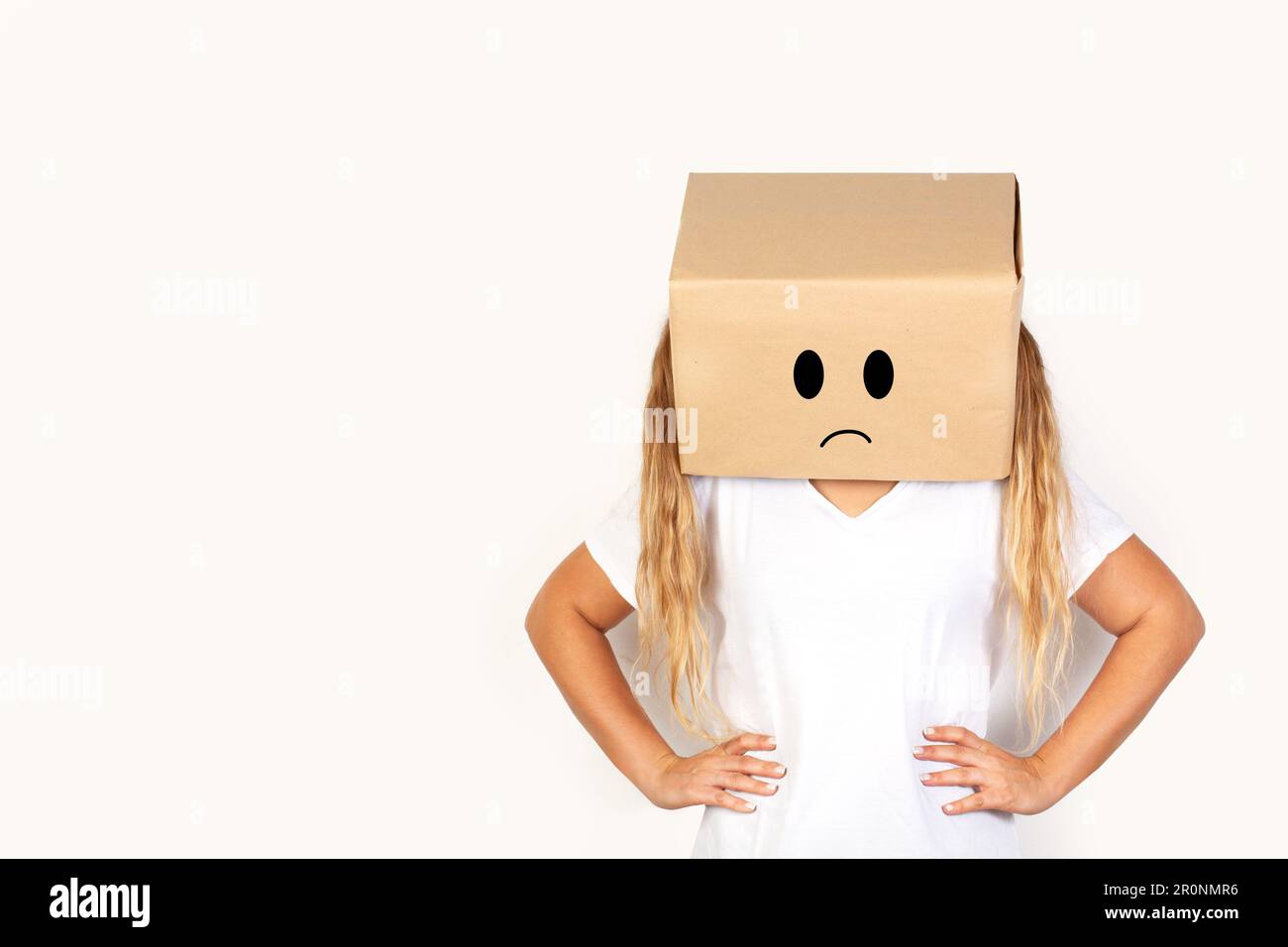 Woman with her head in a box, sad gesture and hands on the hips on a white background with copy space Stock Photo