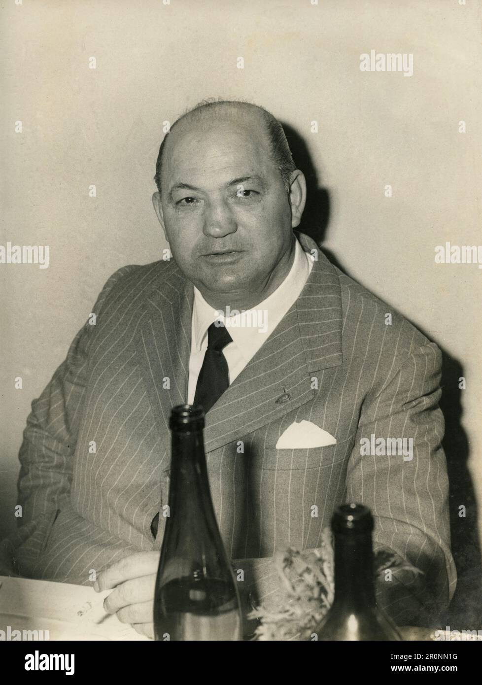 Bald man dressed with a pinstripe suit sitting in the restaurant, Italy 1960s Stock Photo
