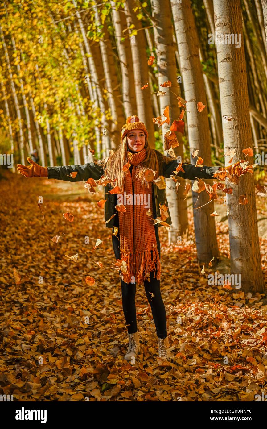 Girl playing with fallen autumn leaves Stock Photo - Alamy