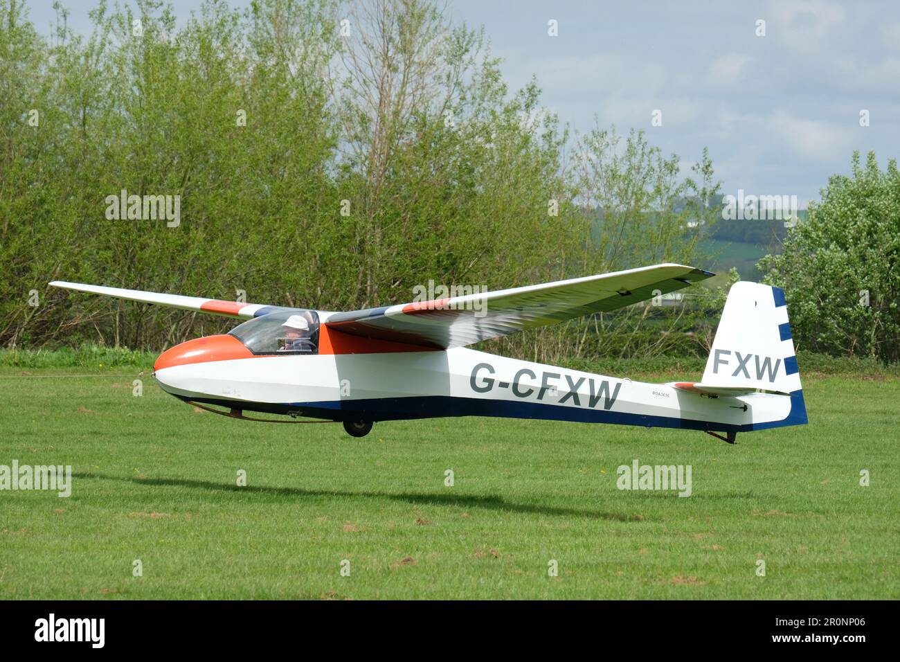 Schleicher K 8B single seat glider taking off by aero tow at Usk airfield Monmouthshire Wales UK in May 2023 Stock Photo