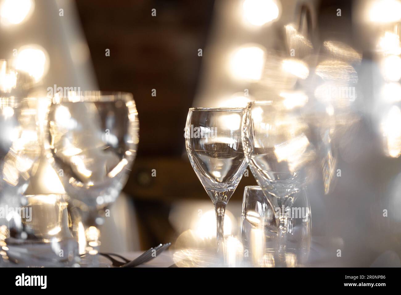 Beautiful table setup glasses for toasts drink with background lights for wedding breakfast
