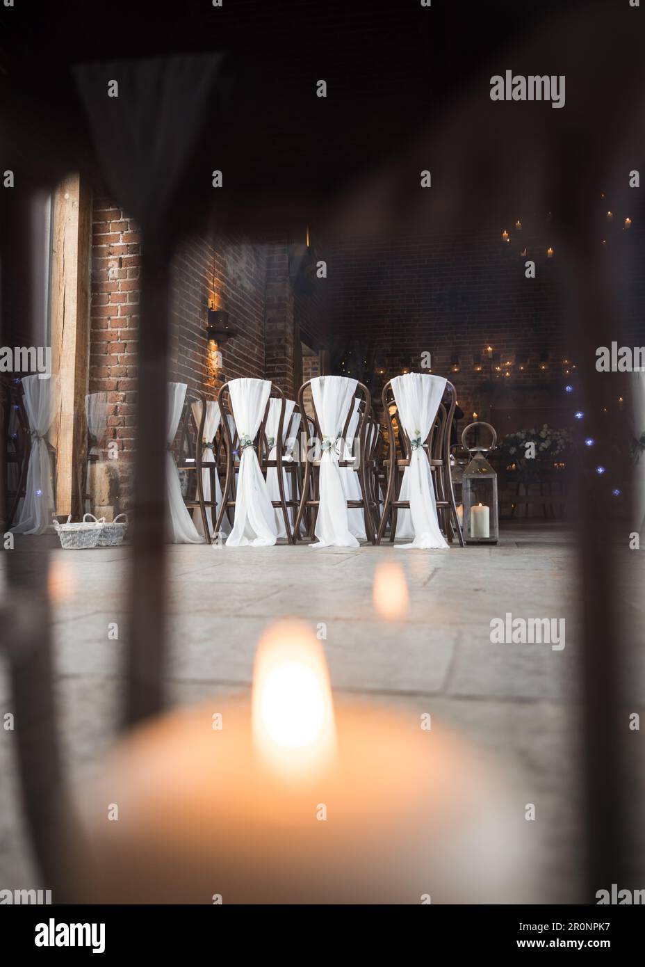 Beautiful candle light wax candles lit in stunning wedding ceremony