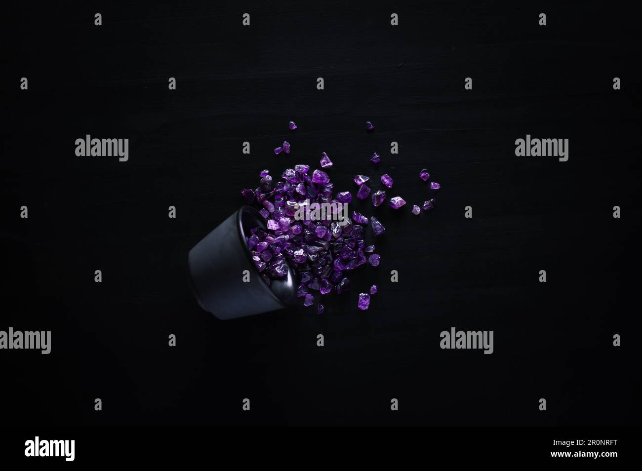 amethyst chips macro detail black background. close-up polished semi-precious gemstone top view copy space. Stock Photo