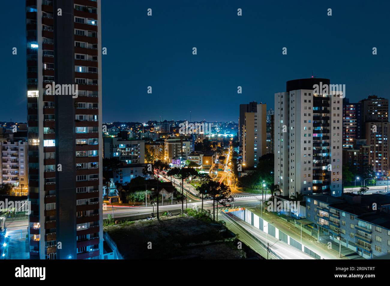 An aerial view of cityscape Curitiba surrounded by buildings in night Stock Photo