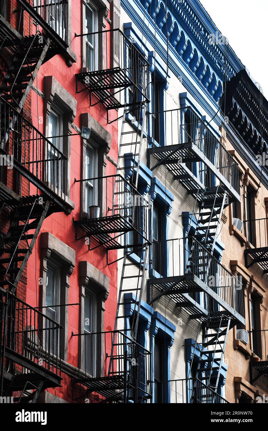 Old residential buildings with iron fire escapes stairs, color applied ...