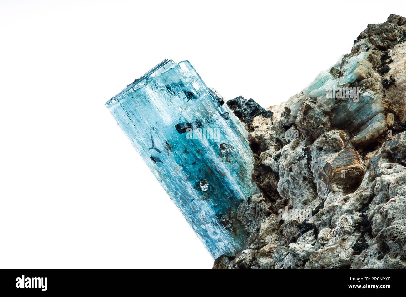 Aquamarine crystal with schorl (black tourmaline) inclusion. macro detail texture background. close-up raw rough unpolished semi-precious gemstone Stock Photo