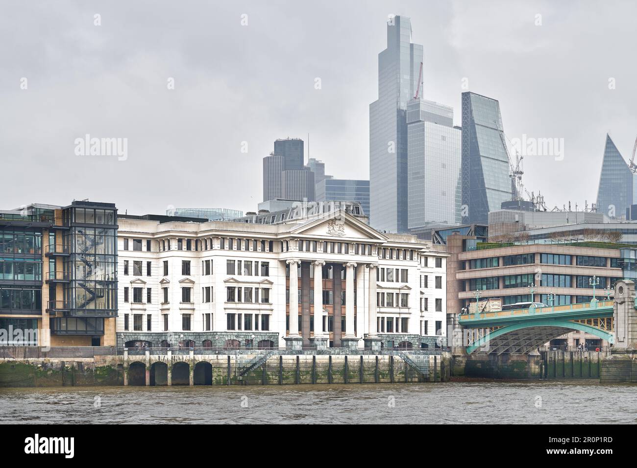 Vintner's Place, on a bank of the river Thames by Southwark bridge, London, England, with the City of London financial district skyscrapers behind. Stock Photo