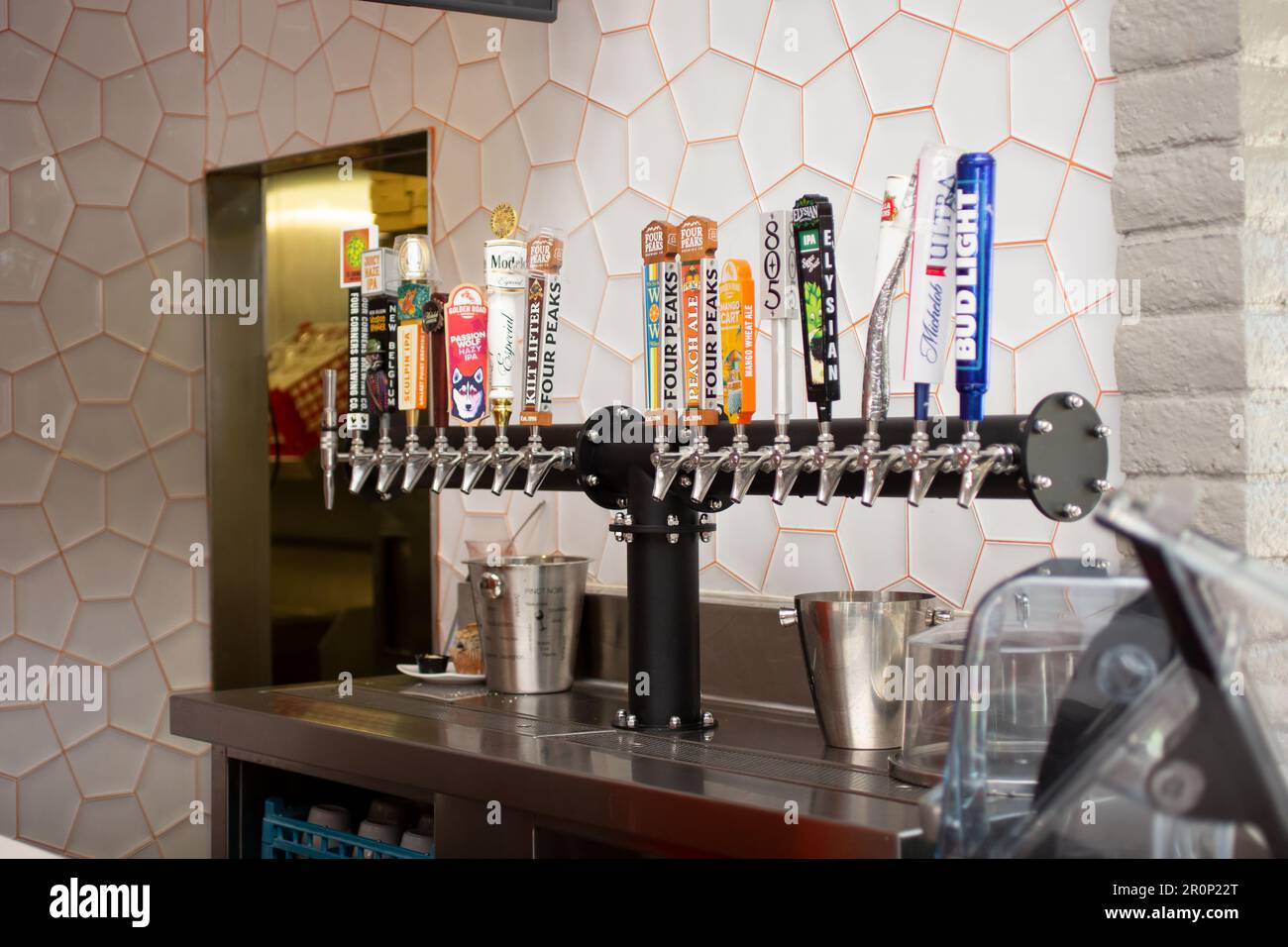 Los Angeles, California, United States - 08-24-2021: A view of several beer taps, featuring brand handles, in a brewery or restaurant setting. Stock Photo