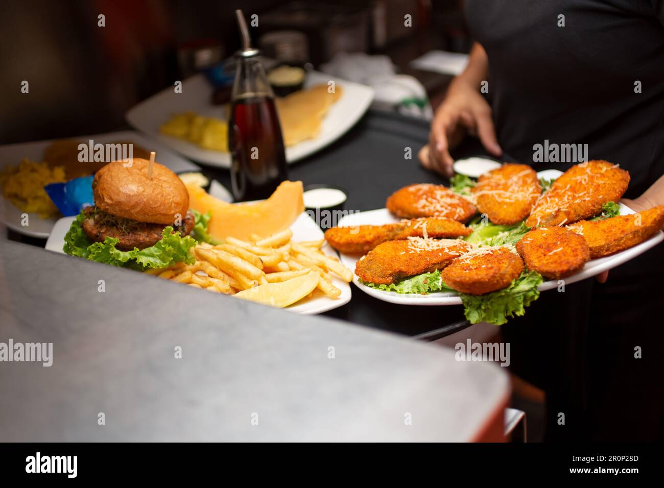 A view of food entrees ready to go in a restaurant kitchen setting