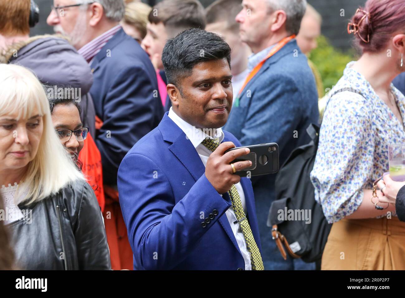 A man takes photos during the Coronation Big Lunch. British Prime Minster, Rishi Sunak and his wife, Akshata Murty host the Coronation Big Lunch in Downing Street in central London following the Coronation of King Charles III on 6 May 2023. The event was attended by community heroes, volunteers, families from Ukraine and special guest First lady, Jill Biden, wife of the President of United States of America, Joe Biden with granddaughter Finnegan Biden. Stock Photo