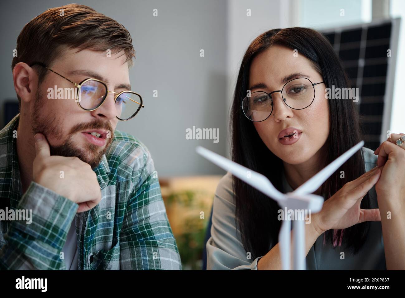 Engineers discussing model of new wind turbine Stock Photo