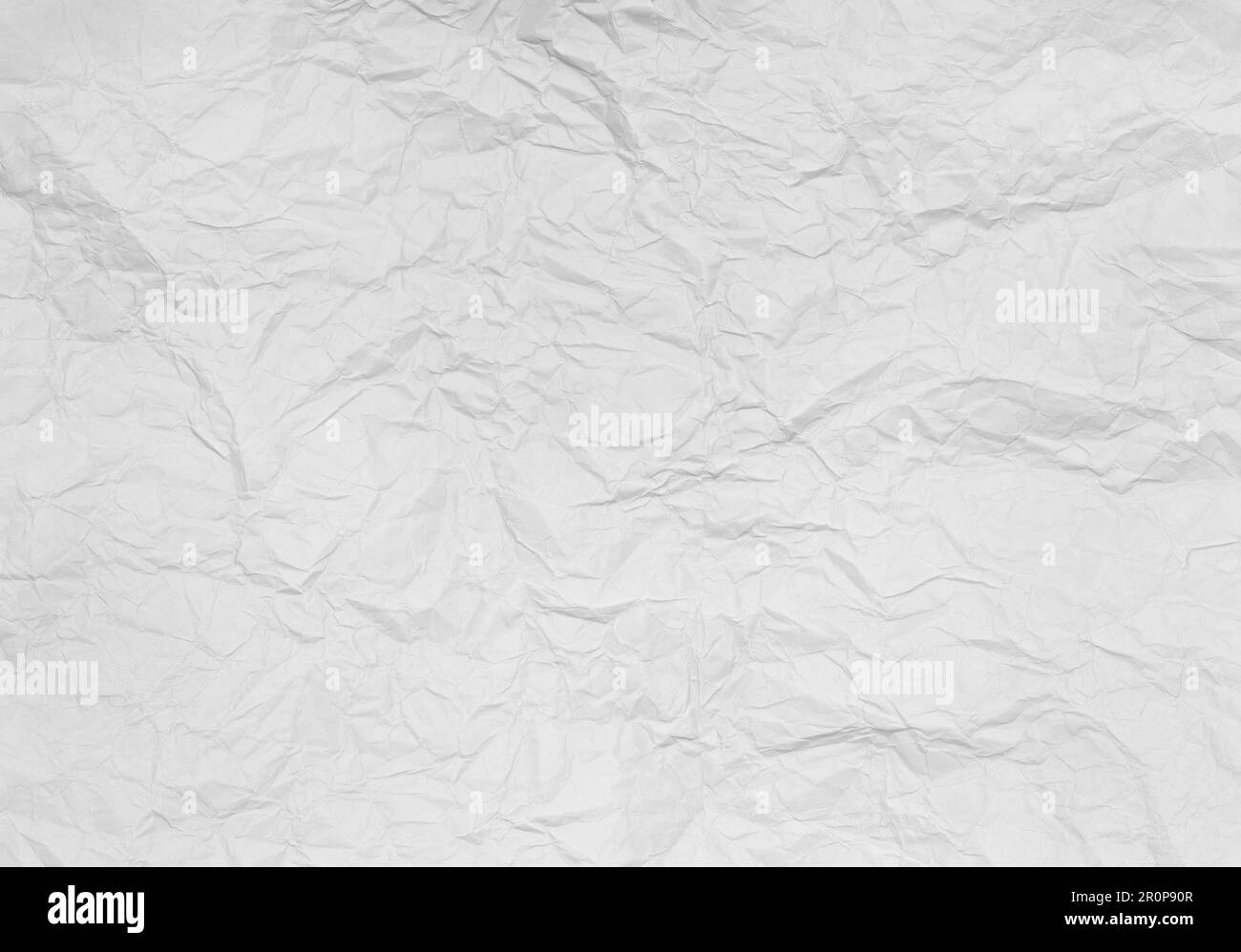 Sheet of white crumpled paper on a white background Stock Photo
