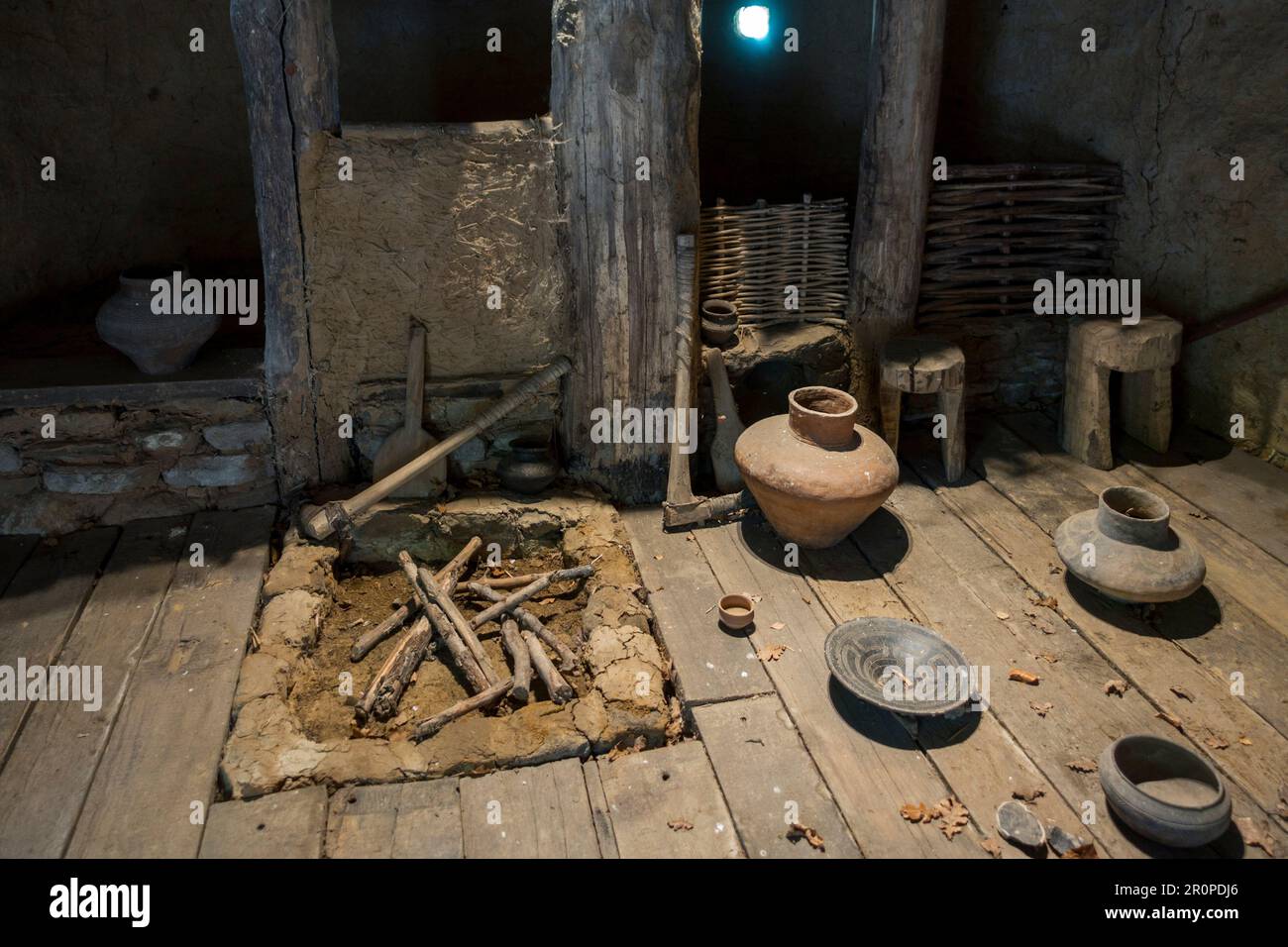 Interior of reconstructed Bronze Age house showing pottery and tools at the open-air Archeosite and Museum of Aubechies-Beloeil, Hainaut, Belgium Stock Photo