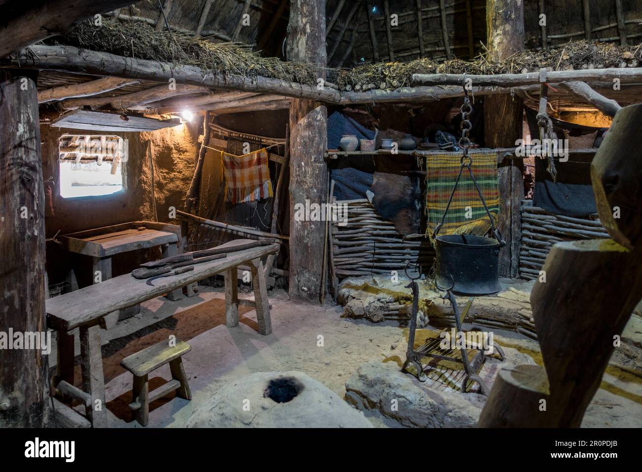 Interior of reconstructed Iron Age house showing furniture and tools at the open-air Archeosite and Museum of Aubechies-Beloeil, Hainaut, Belgium Stock Photo