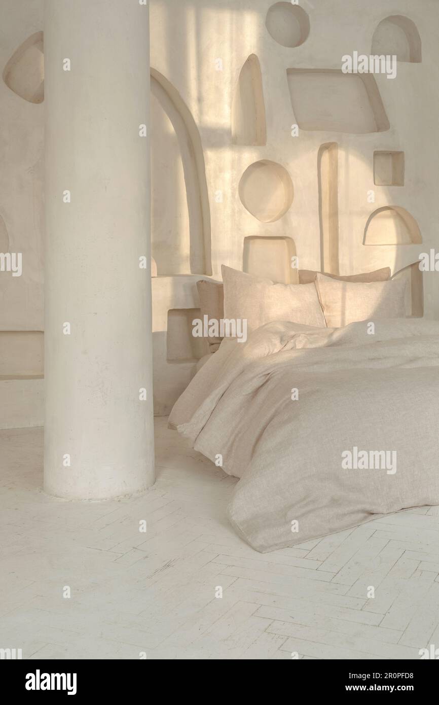 Cozy bedroom interior with trendy organic natural linen bedclothes. Eco