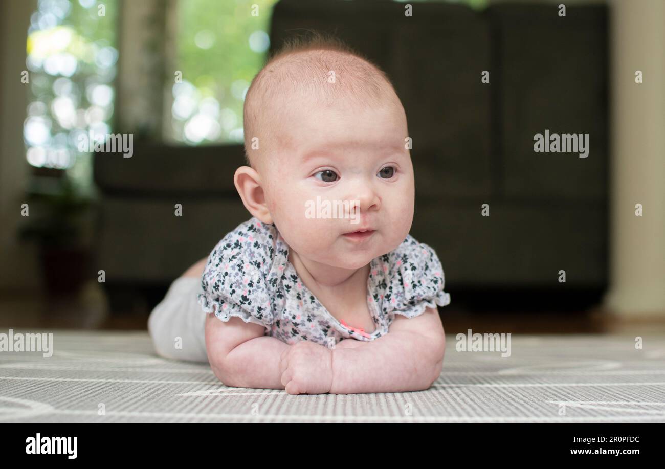 Little baby during tummy time on the baby mat Stock Photo Alamy