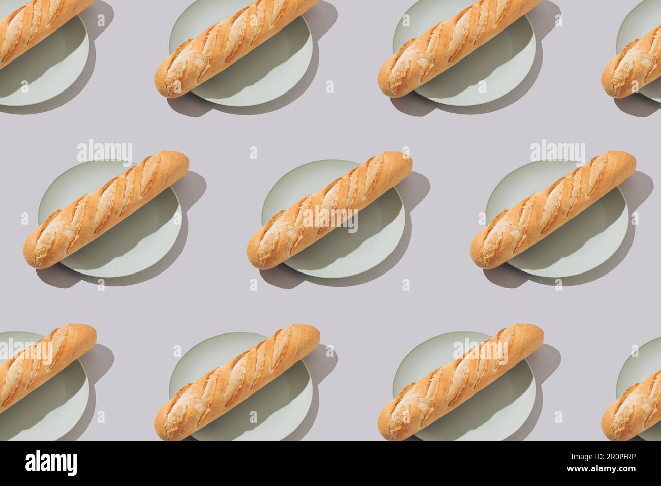Creative food pattern with fresh french baguettes on plates. Minimal concept. Stock Photo