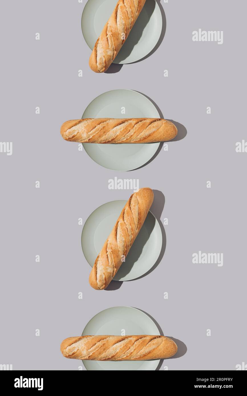 Creative food pattern with fresh French baguettes on plates. Minimal concept. Stock Photo
