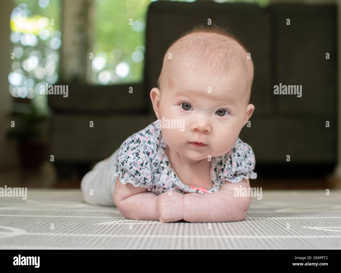 Little baby during tummy time on the baby mat Stock Photo Alamy
