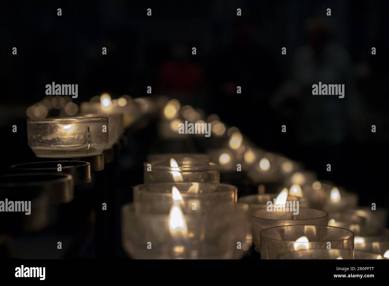 Votive prayer candles inside a catholic church on a candle rack Stock Photo Alamy