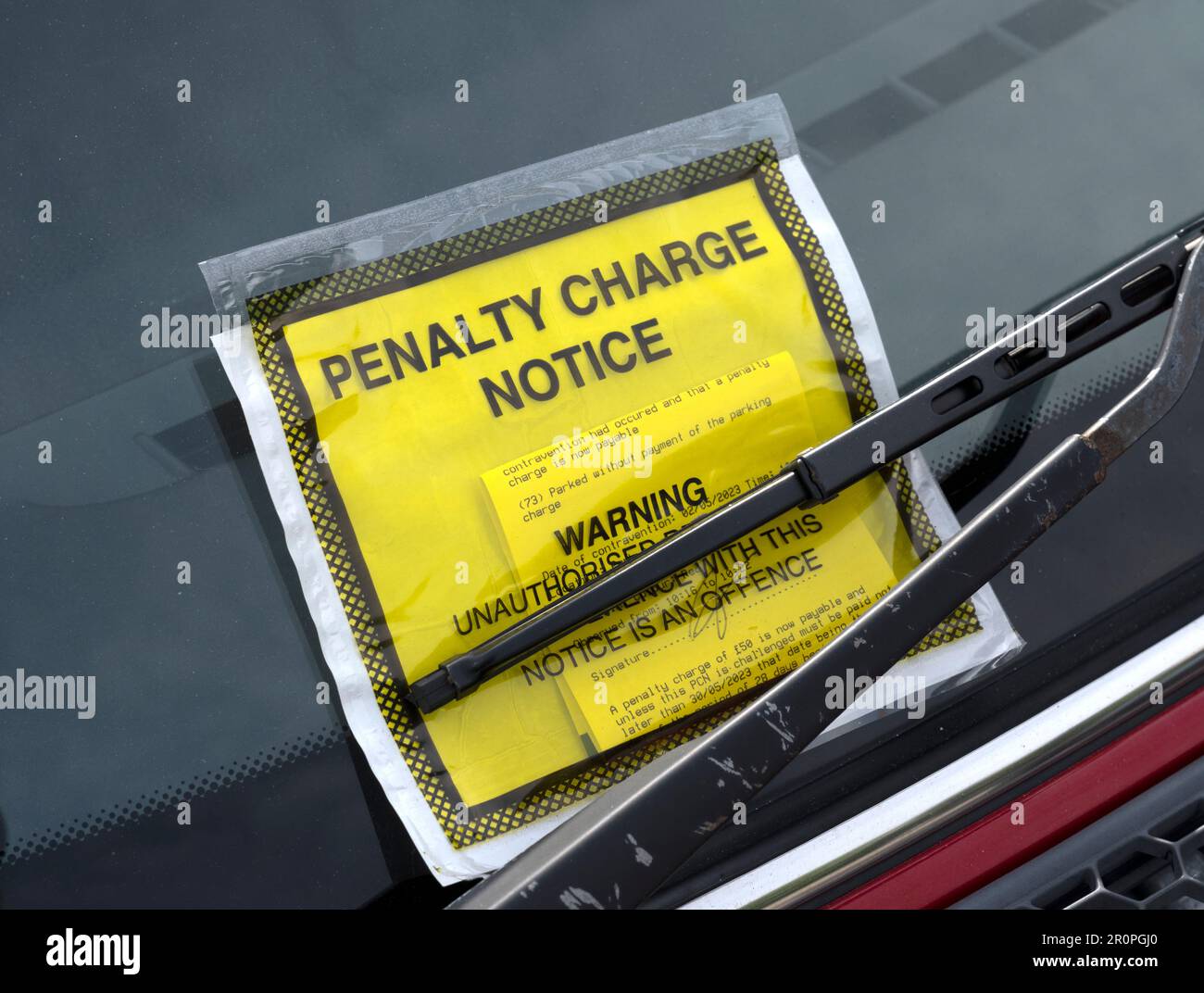 Penalty Charge notice fixed to car windscreen which was in breach of parking regulations, Cornwall, England, UK Stock Photo