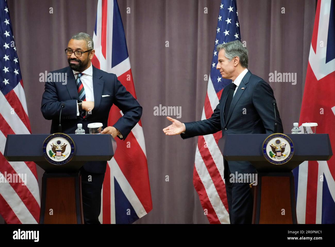 Secretary of State Antony Blinken, right, reaches out to shake hands