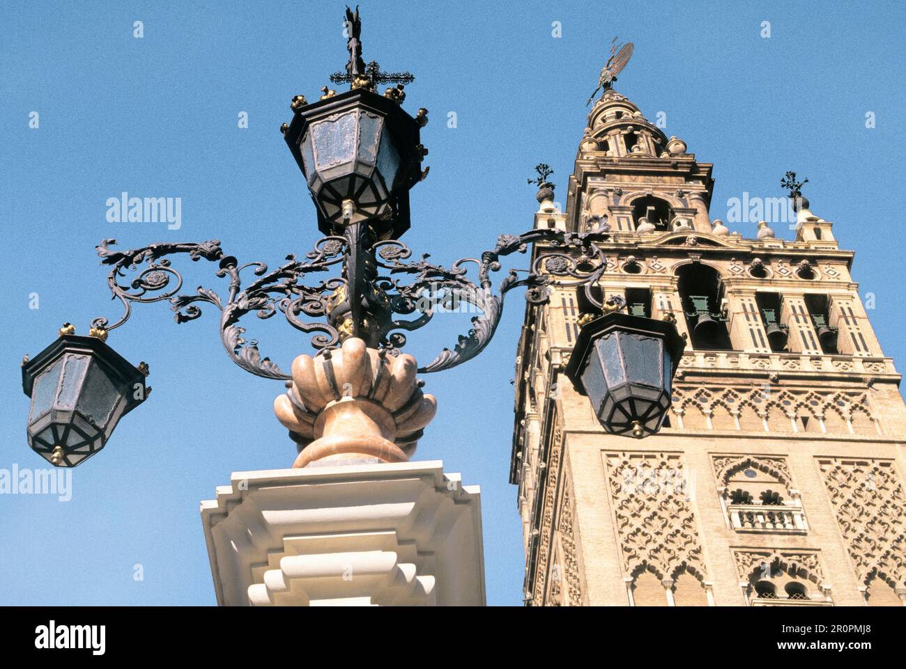La Giralda Cathedral Bell Tower Seville Spain Andalusia  Ornate old street lamp on public square.  Historic UNESCO World Heritage Site. Landmark day Stock Photo