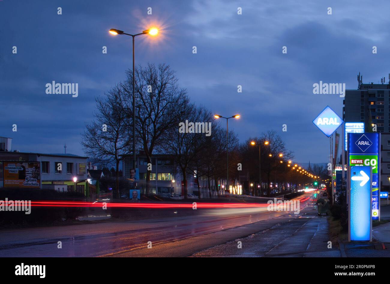 Kaiserslautern, Germany March 4, 2021 Red light trails from a car driving next to an Aral gas