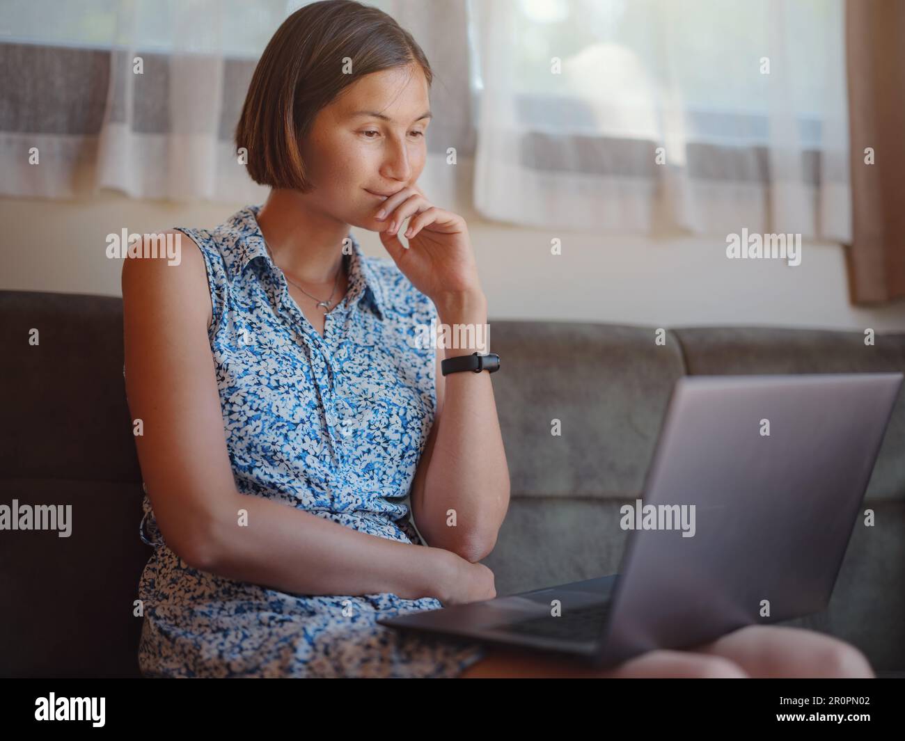 Beautiful lady work on notepad sit on sofa at home - check online shopping for cyber monday sales - technology woman concept for alternative freelance Stock Photo