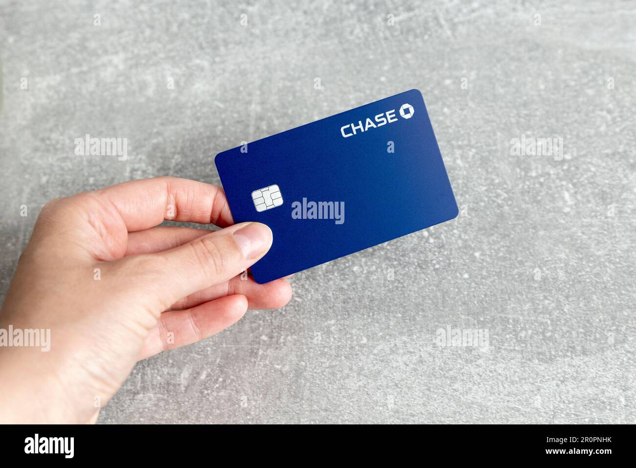 Hand holding a Chase cashback debit card Stock Photo