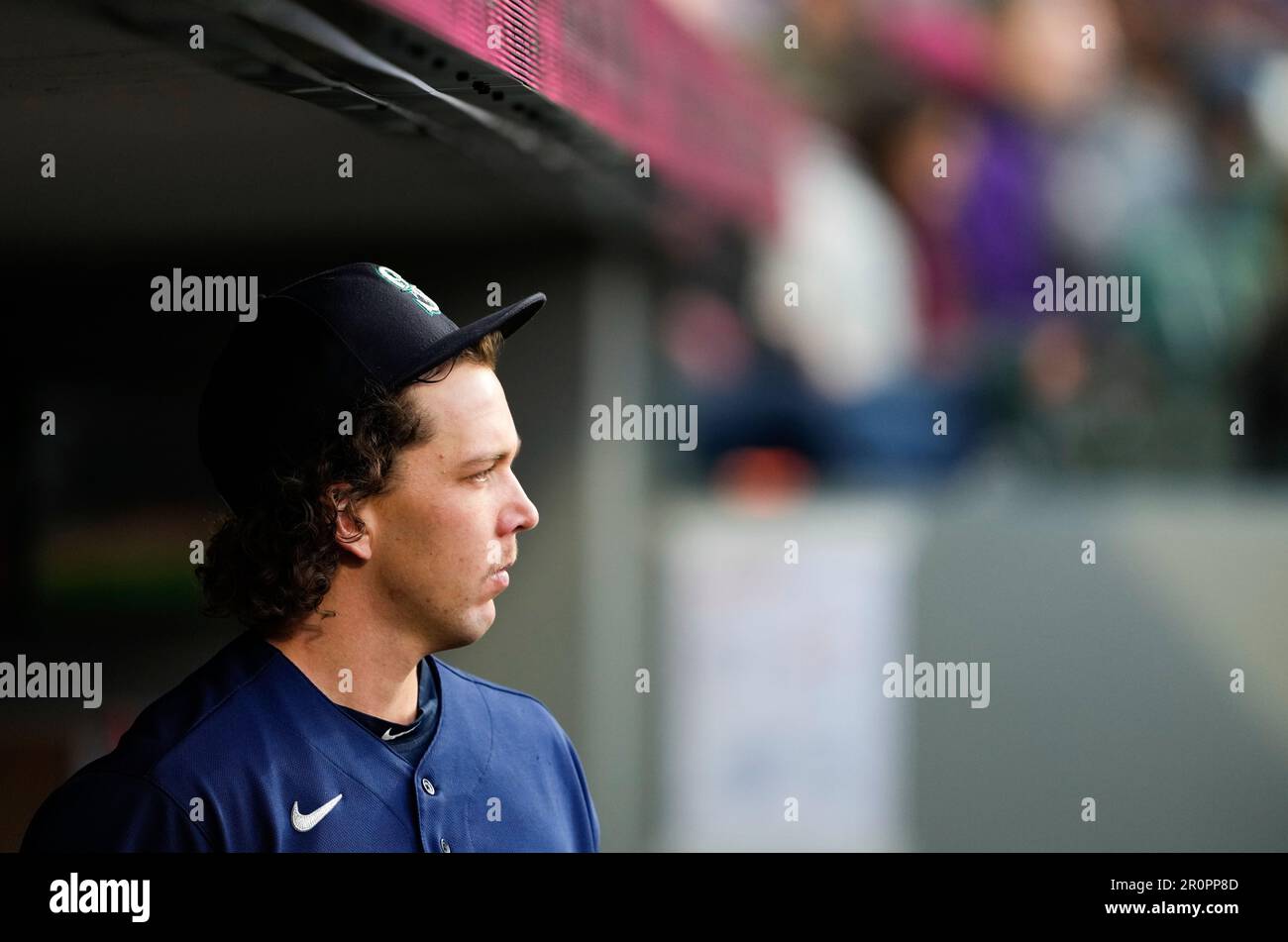 Seattle Mariners starting pitcher Logan Gilbert walks in the dugout during a baseball game