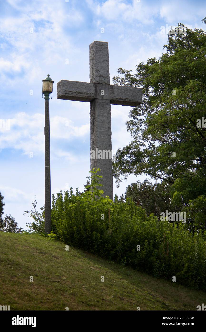 Big Cross and a Lantern on a Hill Against the Blue Sky Stock Photo