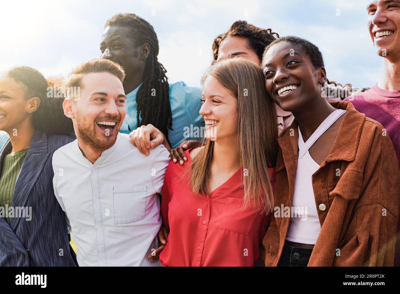 Diverse group of friends having fun smiling outdoor in summer day - Young people celebrate holiday vacations outside Stock Photo