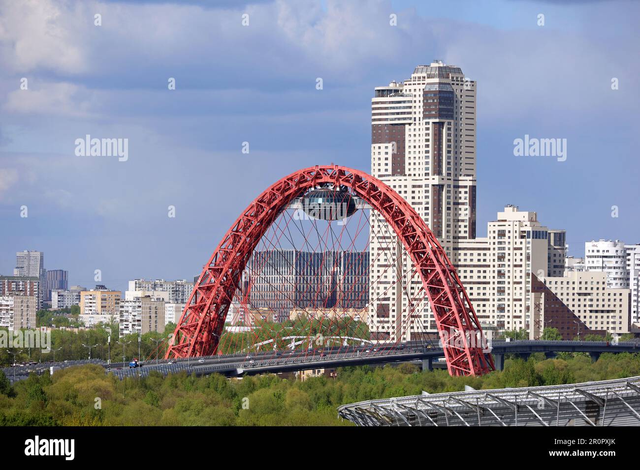 View of red cable-stayed Zhivopisny bridge in Moscow and modern residential buildings Stock Photo